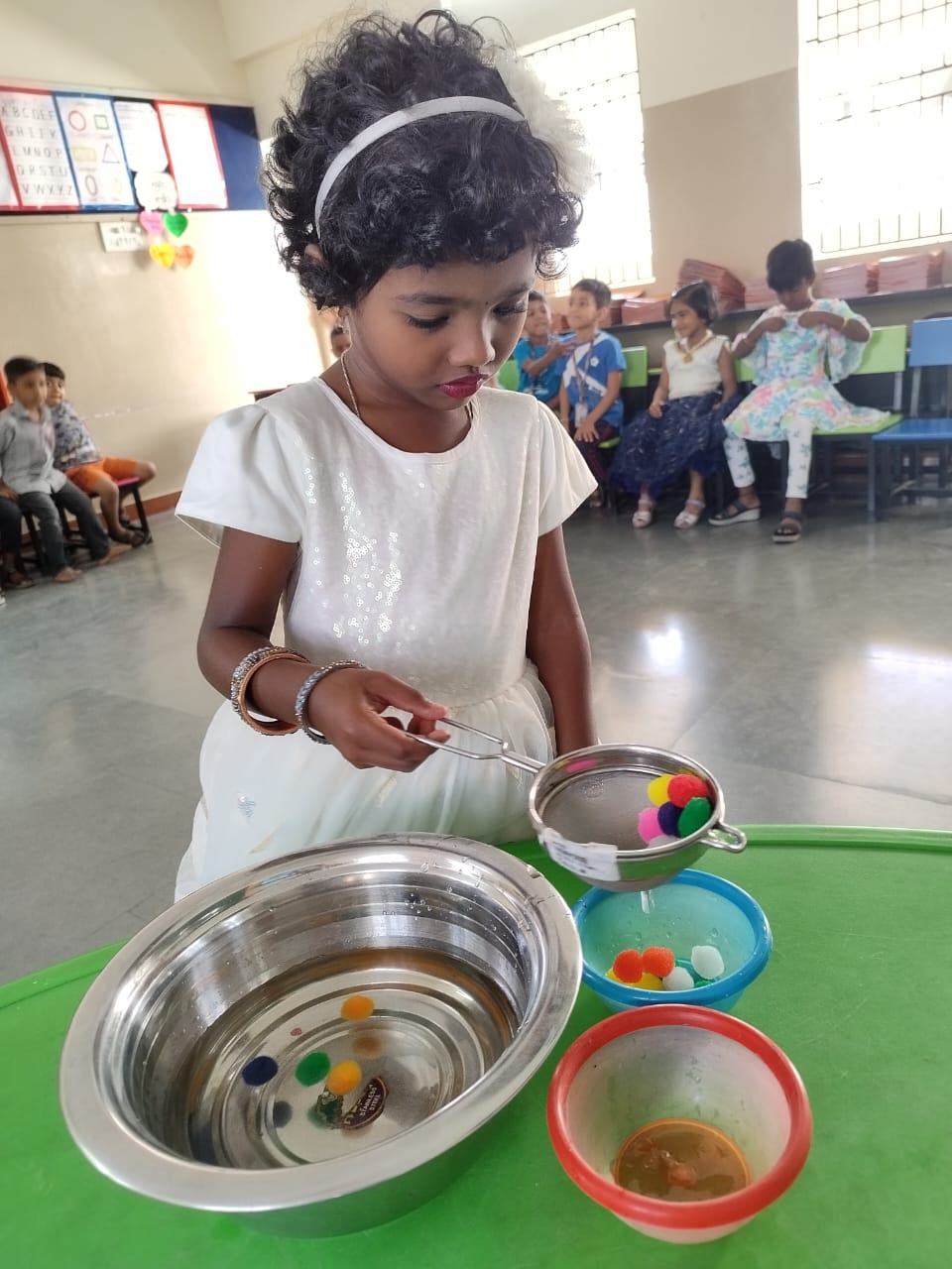 Focused hands, colourful catches-scooping up the fun!