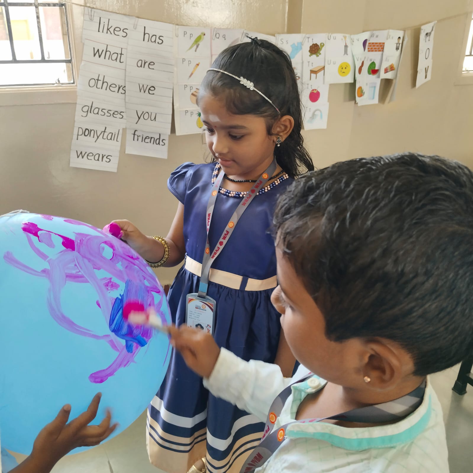 Little hands creating magic in balloon!