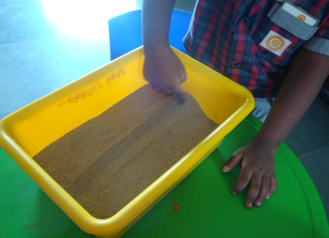 Sand is a sensory toy for kids as they explore their sense of touch. 