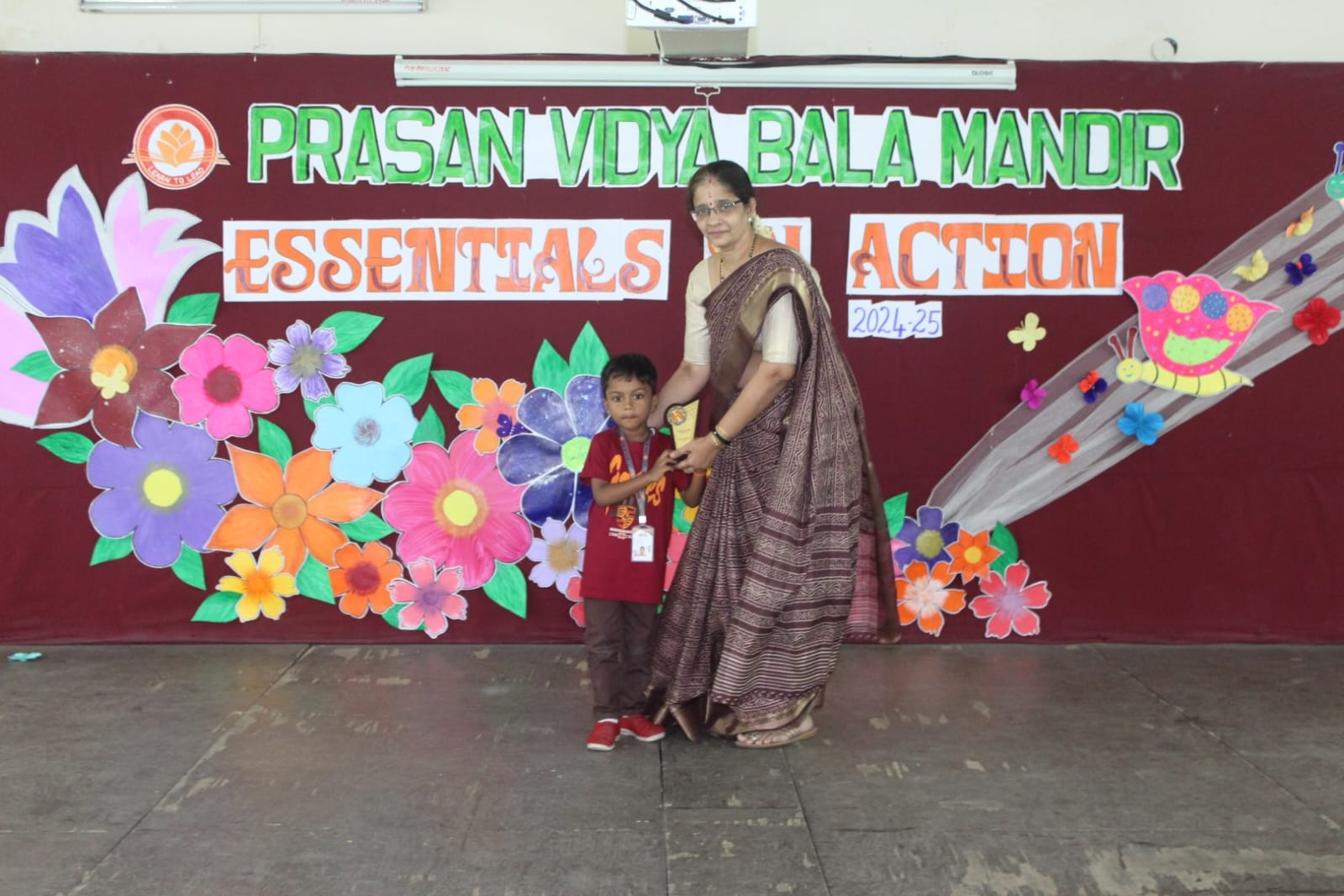 Small hands, big dreams, holding a trophy of success.
