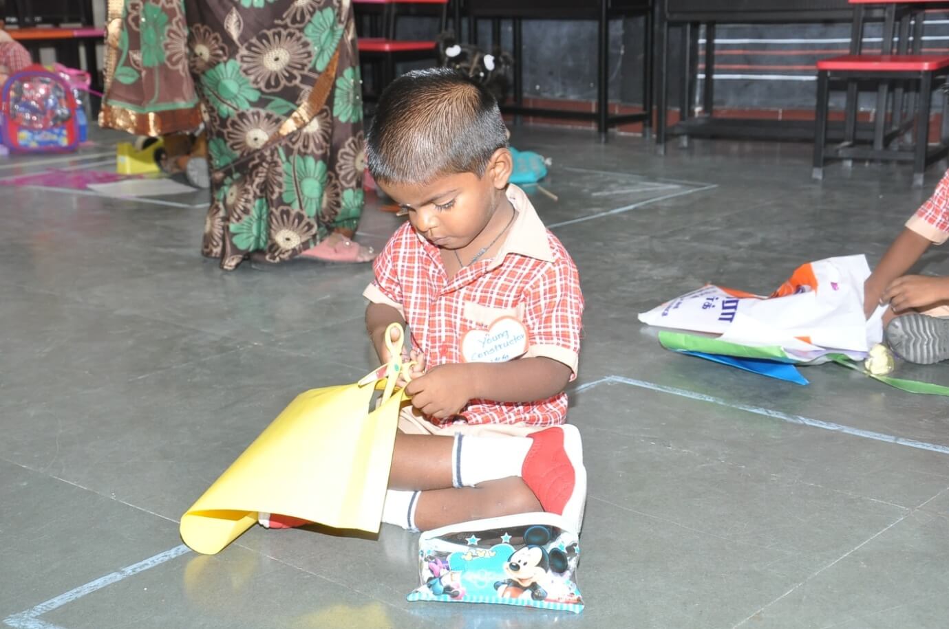 Here is our young constructor in the  kite making process.