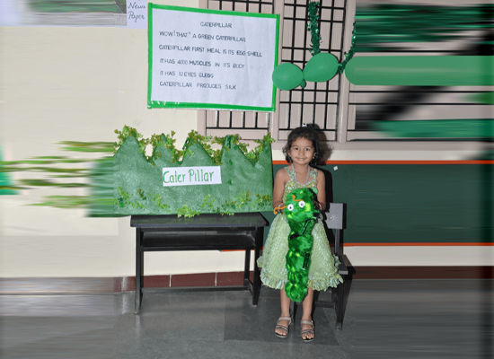 Charming girl with her green caterpilar.